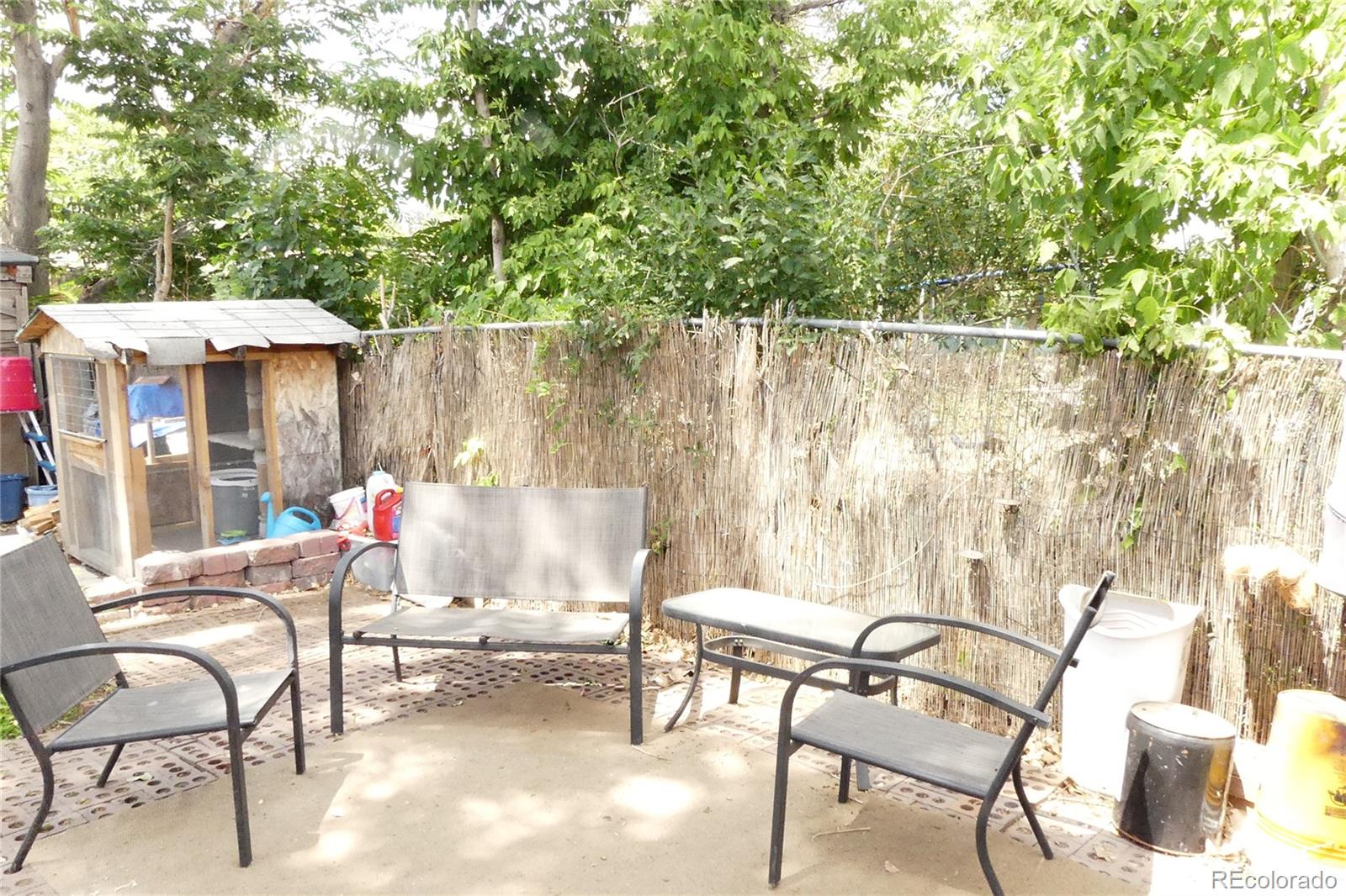 4851 Adams Street Denver, CO 80216 - Photo 17 of 30 an outdoor sitting area with couch and chairs