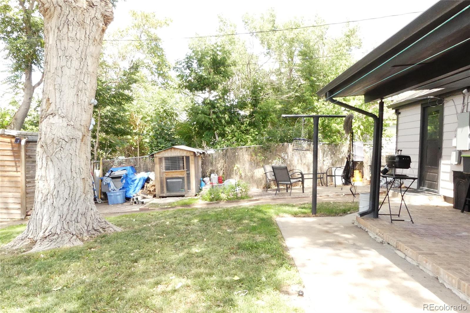 4851 Adams Street Denver, CO 80216 - Photo 18 of 30 a view of a house with backyard and sitting area