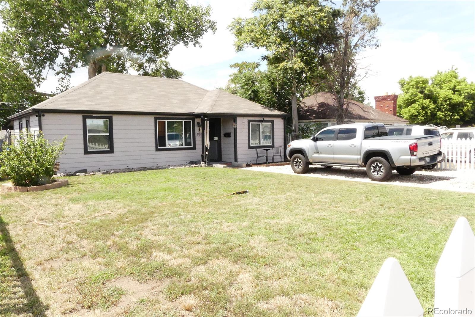 4851 Adams Street Denver, CO 80216 - Photo 2 of 30 a view of house that has a yard