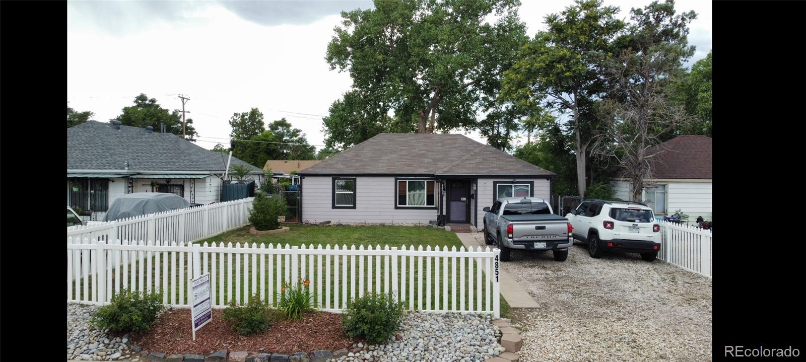 4851 Adams Street Denver, CO 80216 - Photo 22 of 30 a front view of a house with a garden