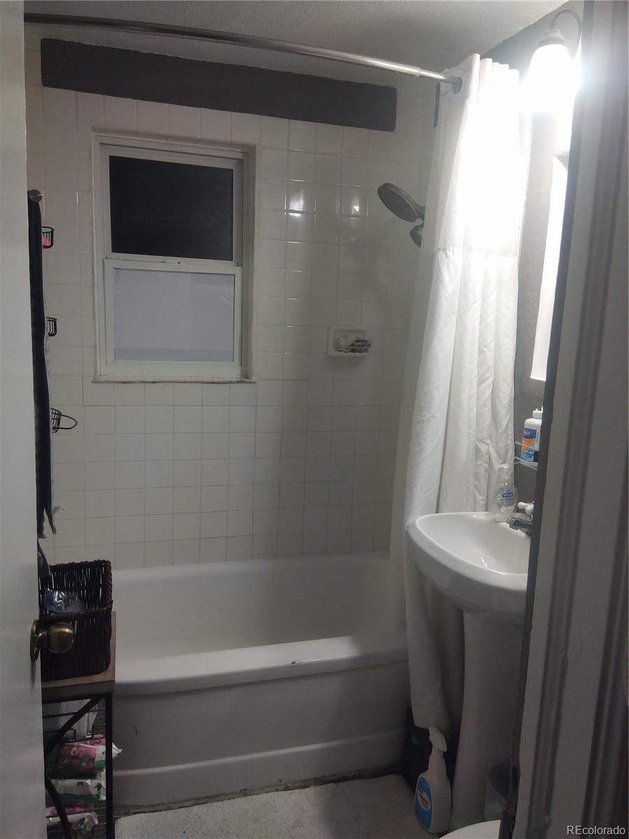 4851 Adams Street Denver, CO 80216 - Photo 25 of 30 a bathroom with a shower