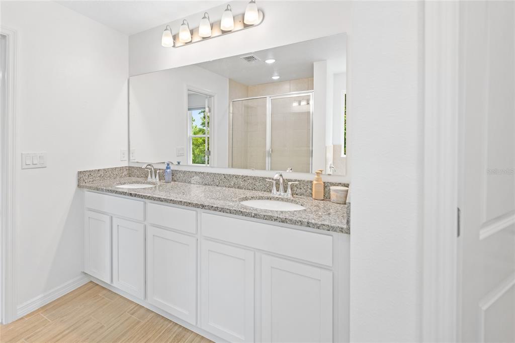 1137 Bradford Rdg Drive Leesburg, FL 34748 - Photo 18 of 37 a bathroom with a double vanity sink and a mirror
