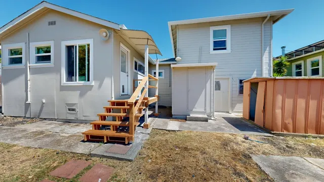 a backyard of a house with outdoor seating