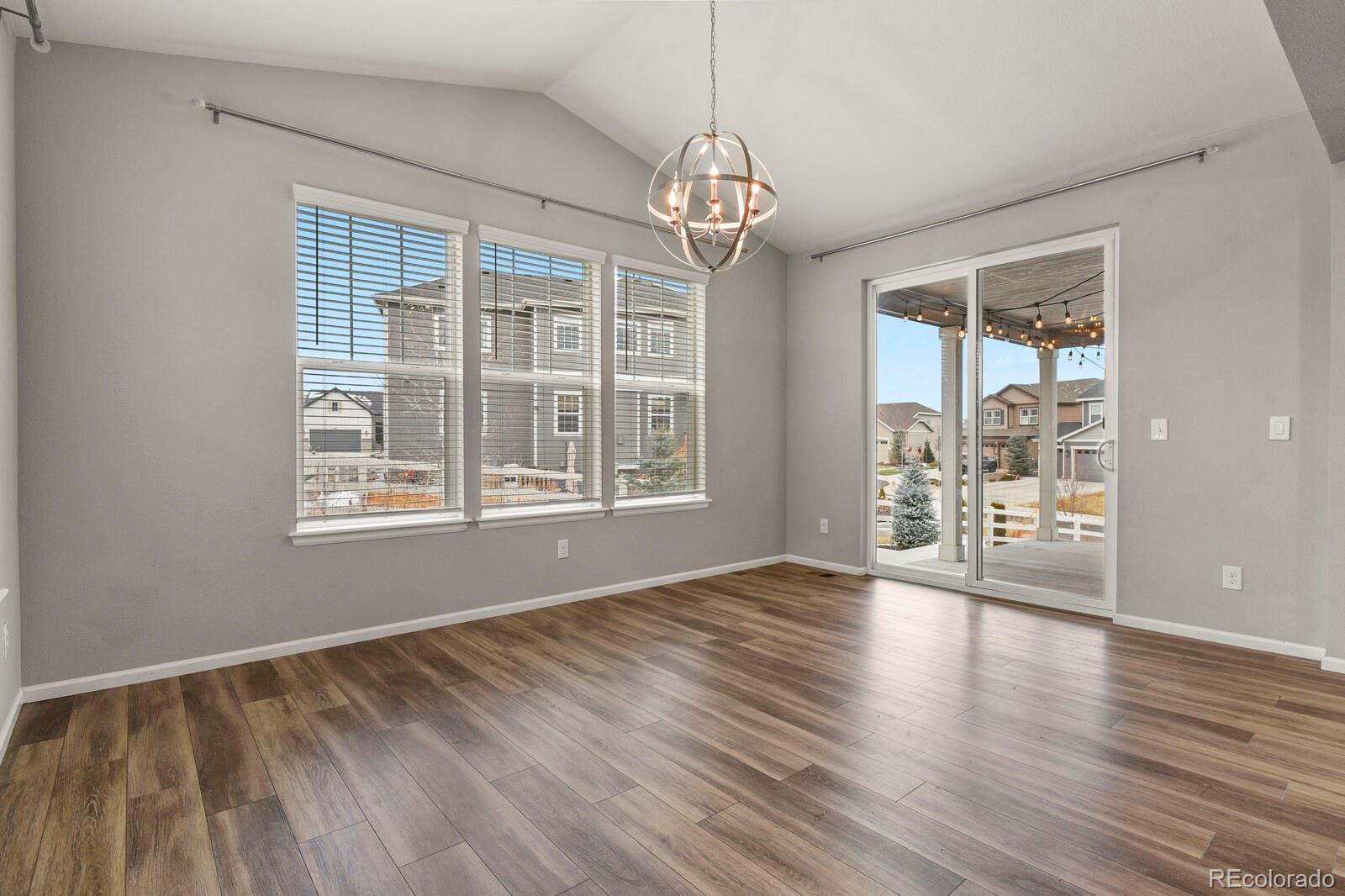 5723 Berry Ridge Wy. Castle Rock, CO 80104 - Photo 11 of 48 a view of an empty room with wooden floor and a window