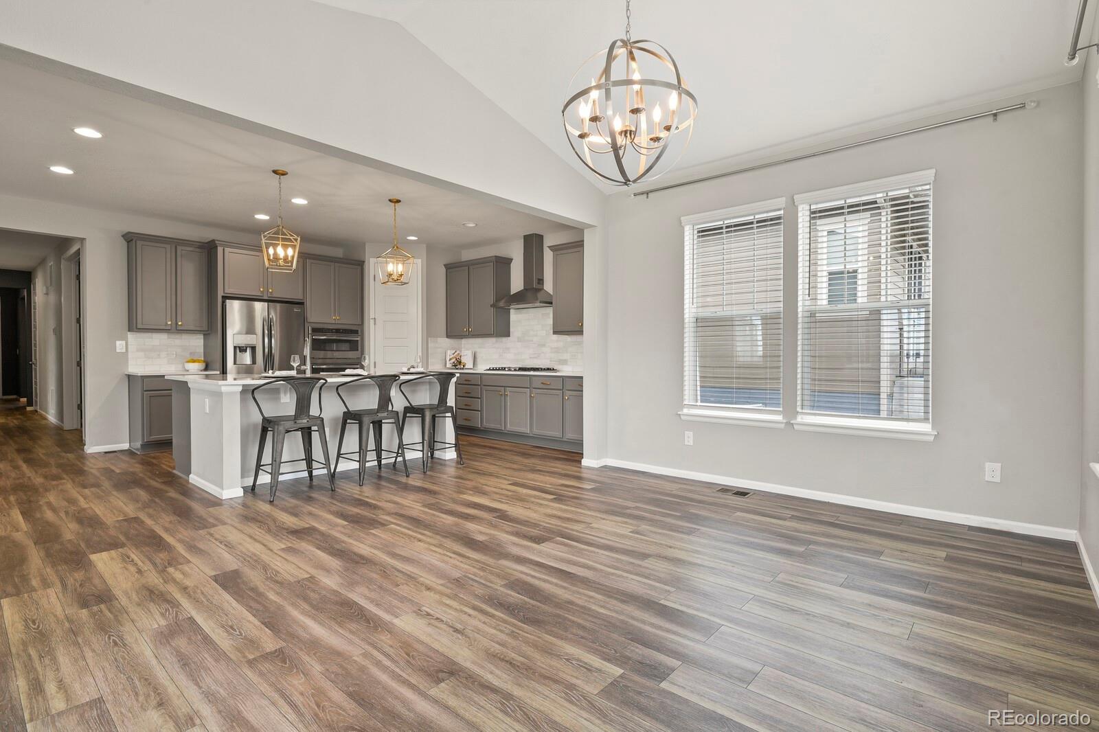 5723 Berry Ridge Wy. Castle Rock, CO 80104 - Photo 13 of 48 a view of a dining room with furniture wooden floor and chandelier