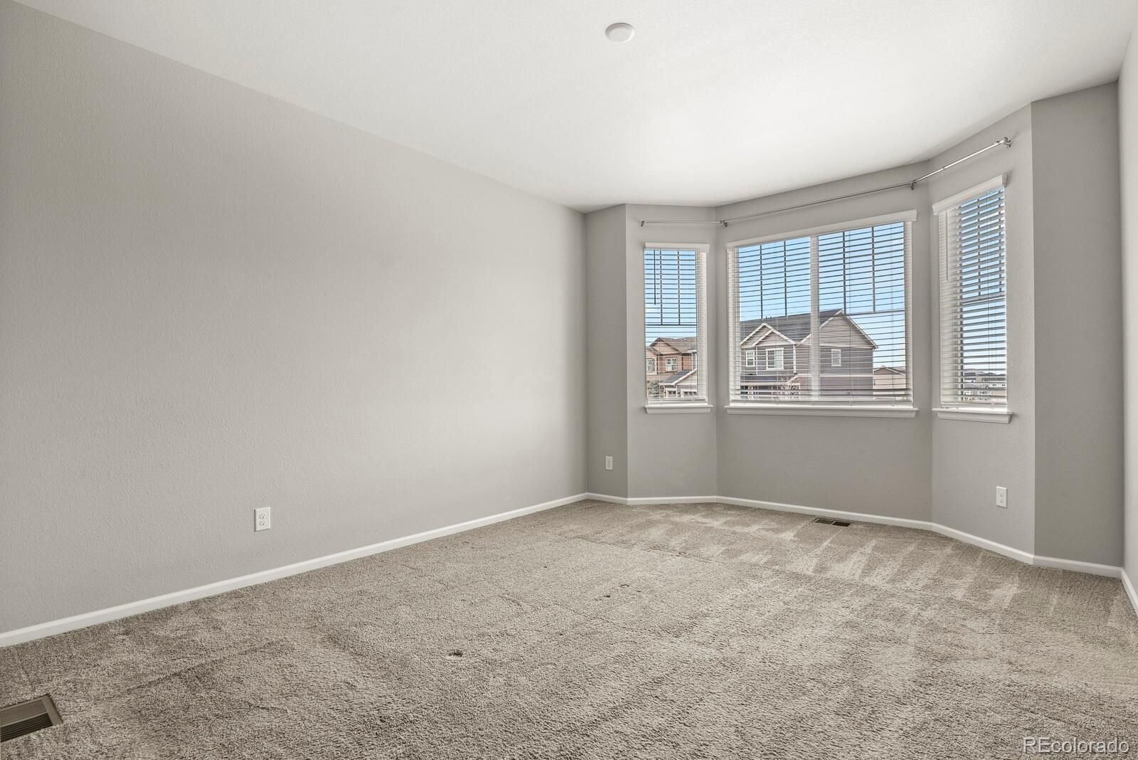 5723 Berry Ridge Wy. Castle Rock, CO 80104 - Photo 18 of 48 an empty room with windows
