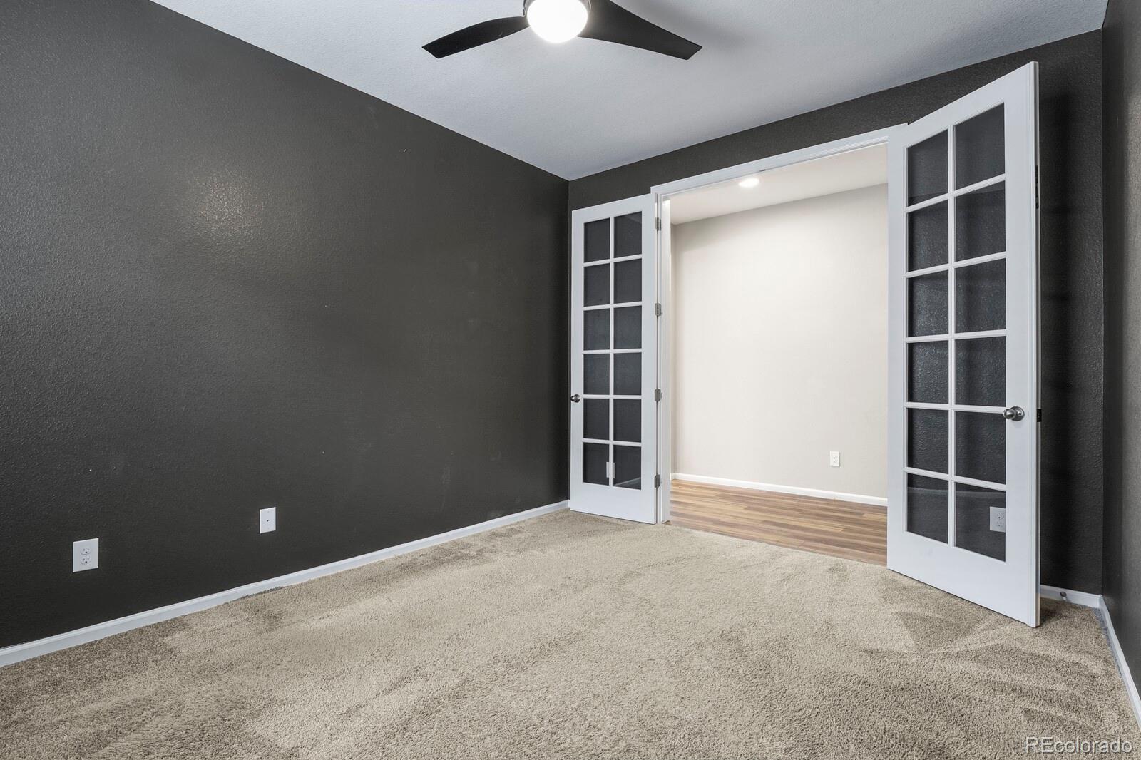 5723 Berry Ridge Wy. Castle Rock, CO 80104 - Photo 25 of 48 a view of an empty room with a fireplace and cabinet