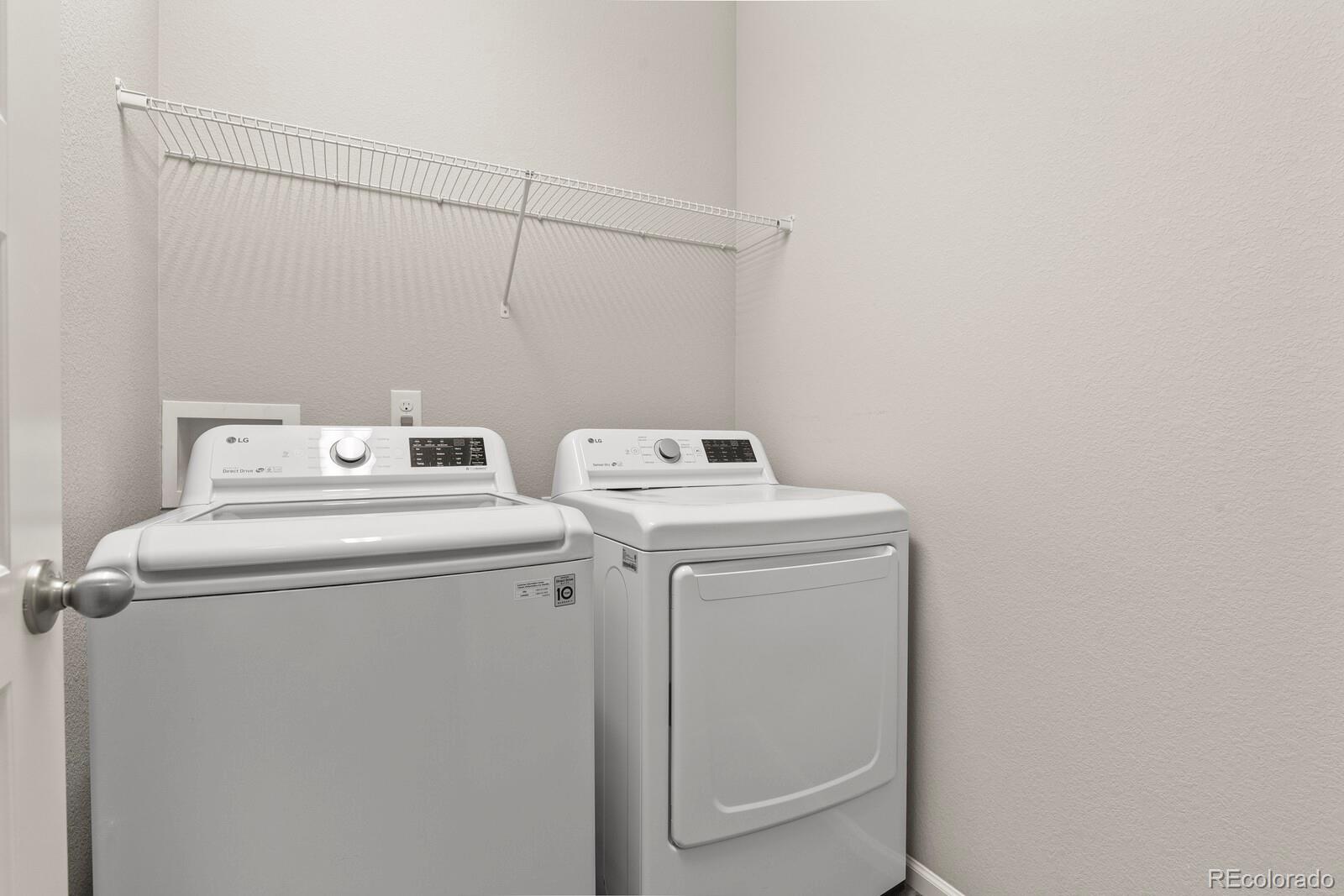 5723 Berry Ridge Wy. Castle Rock, CO 80104 - Photo 31 of 48 a utility room with dryer and washer
