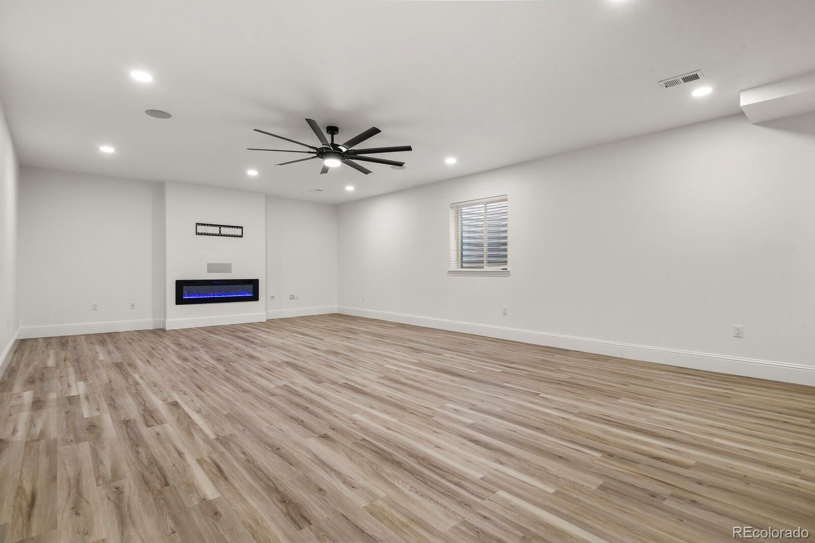 5723 Berry Ridge Wy. Castle Rock, CO 80104 - Photo 34 of 48 a view of an empty room with a window and a ceiling fan