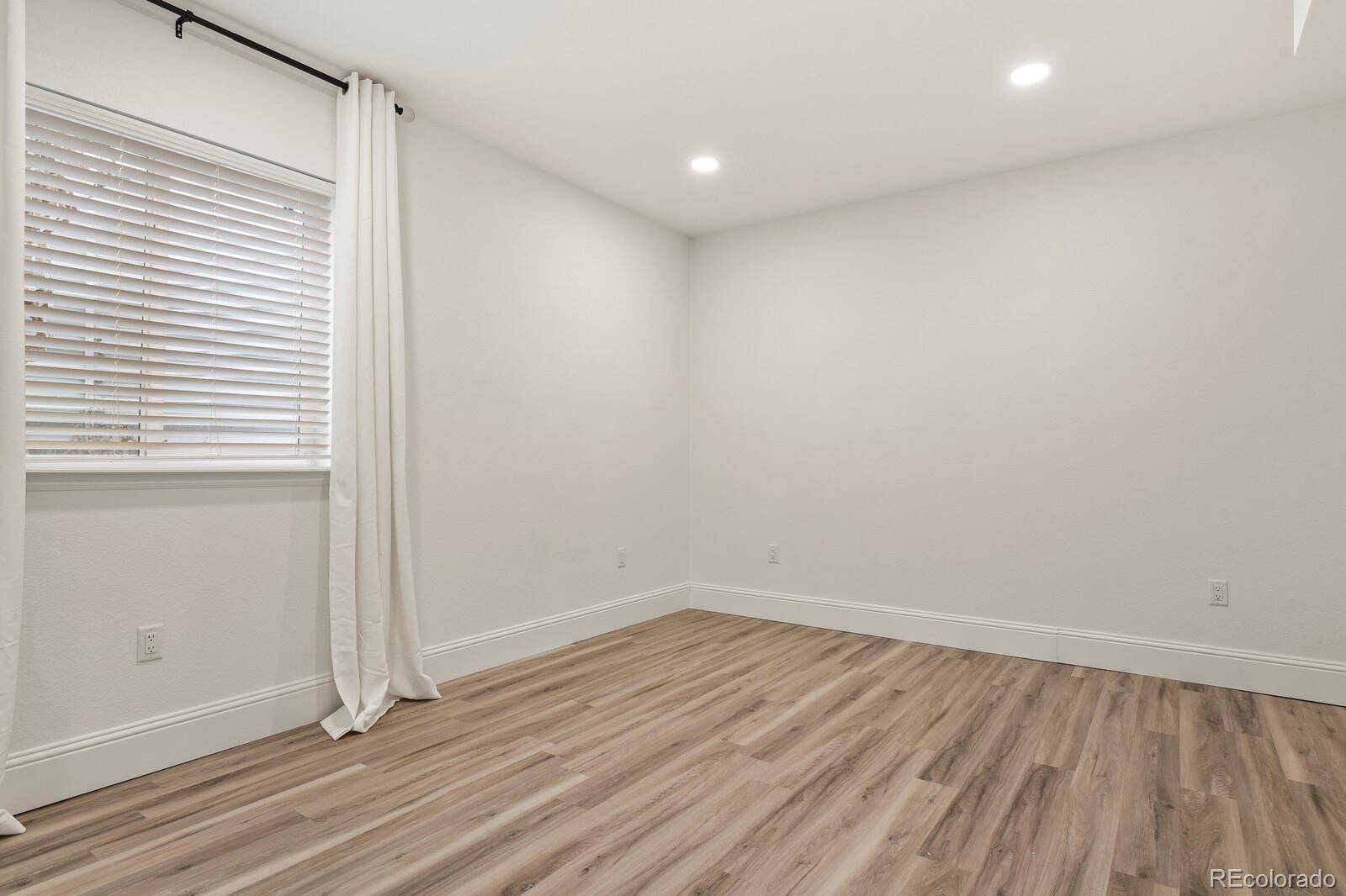 5723 Berry Ridge Wy. Castle Rock, CO 80104 - Photo 39 of 48 a view of a room with wooden floor and white walls