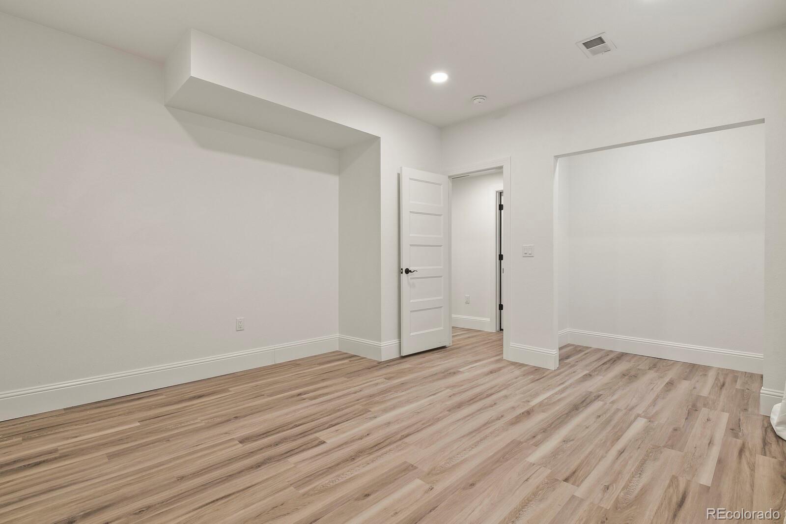 5723 Berry Ridge Wy. Castle Rock, CO 80104 - Photo 40 of 48 a view of an empty room with wooden floor