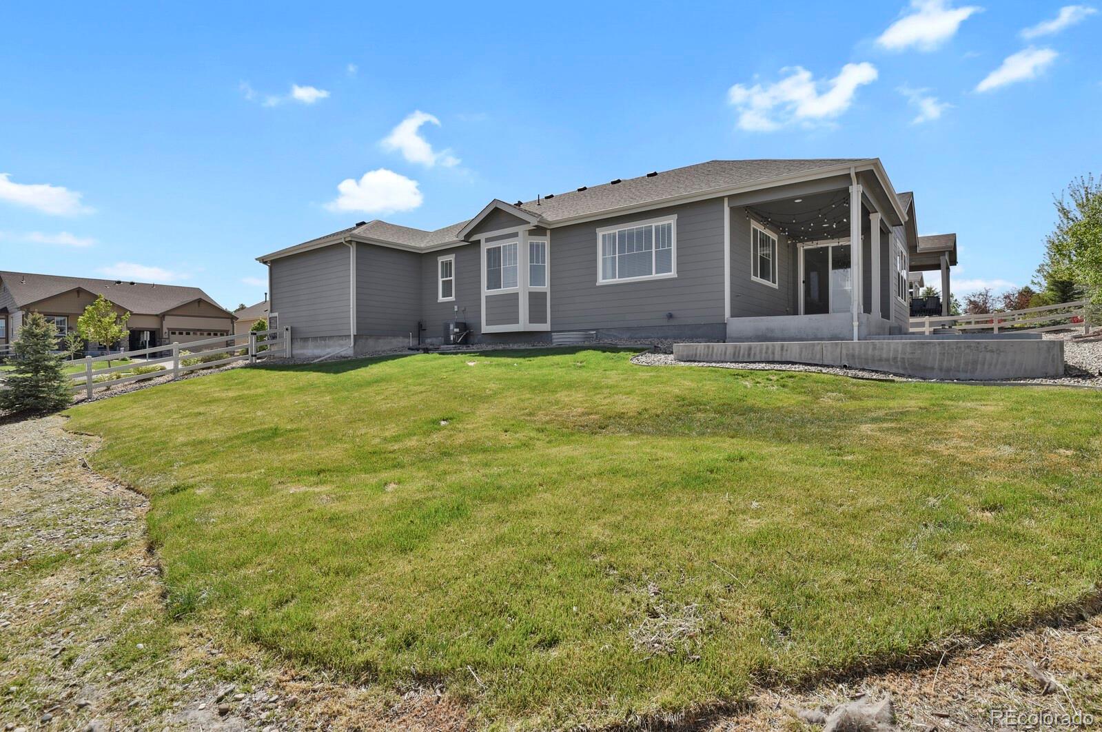 5723 Berry Ridge Wy. Castle Rock, CO 80104 - Photo 44 of 48 a view of a house with yard and dinning table and chairs