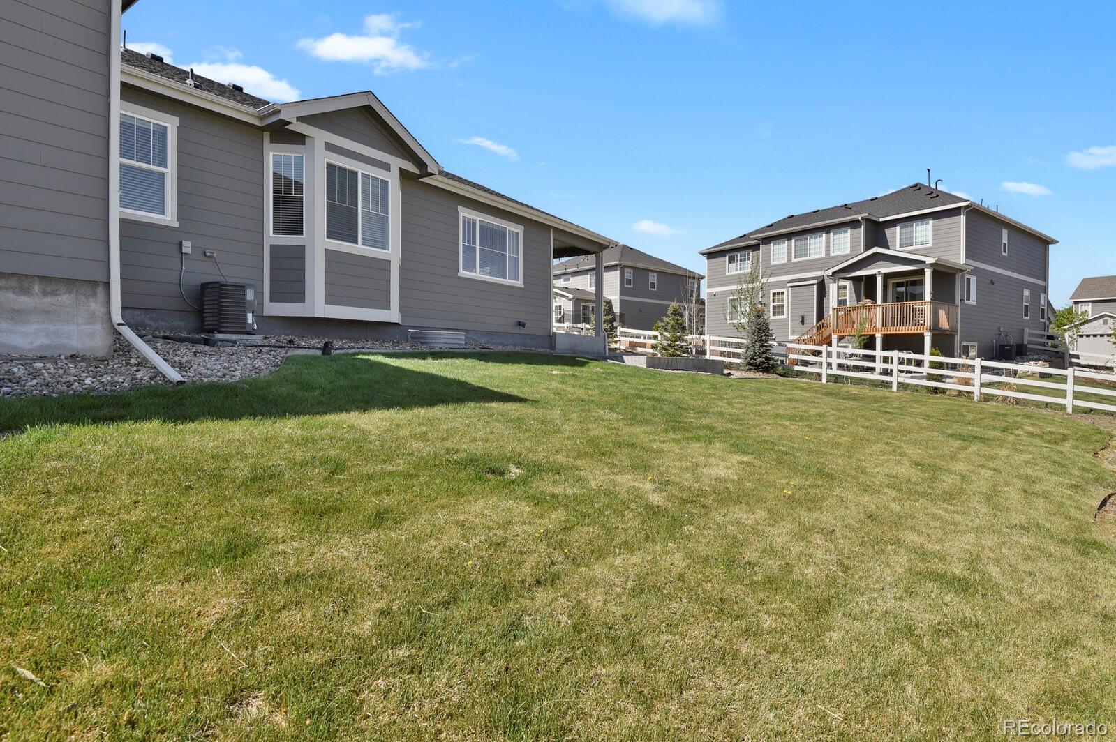 5723 Berry Ridge Wy. Castle Rock, CO 80104 - Photo 45 of 48 a front view of a house with a yard