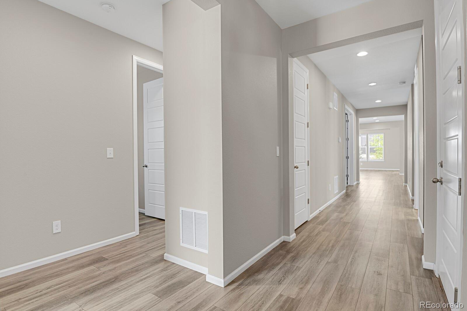 5723 Berry Ridge Wy. Castle Rock, CO 80104 - Photo 5 of 48 a view of a hallway with wooden floor