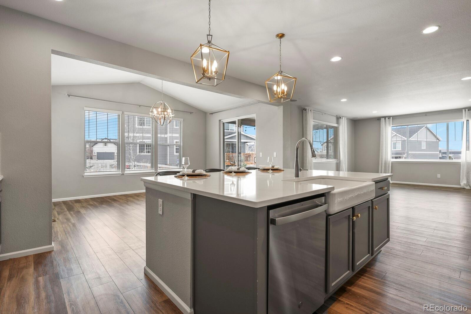 5723 Berry Ridge Wy. Castle Rock, CO 80104 - Photo 9 of 48 a kitchen with stainless steel appliances granite countertop counter space and wooden floors