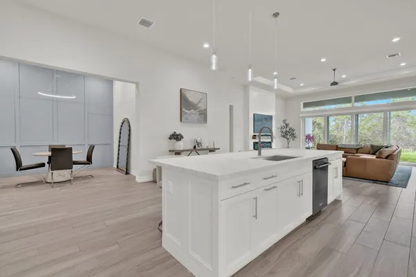a large white kitchen with a large window