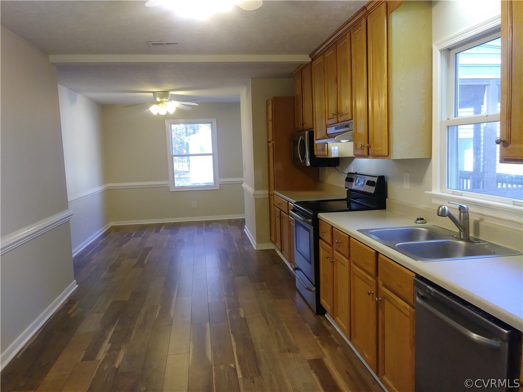 8320 Fredericks Hall Road Mineral, VA 23117 - Photo 11 of 39 a kitchen with wooden floors and wooden cabinets