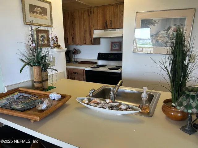 a kitchen with a sink and a stove