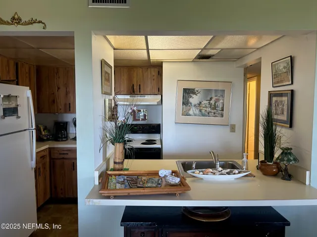 a kitchen with a sink stove and refrigerator