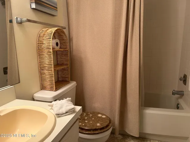 a bathroom with a sink toilet and bathtub