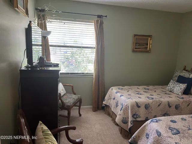 a bedroom with a bed and chair