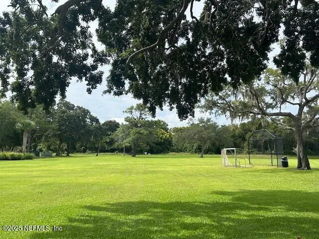 a front view of a house with a big yard