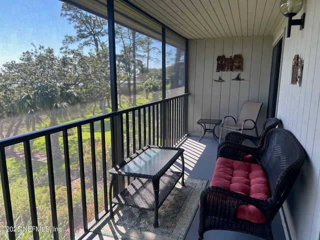 a view of a balcony with furniture