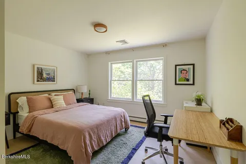 a bedroom with a bed a table and chair