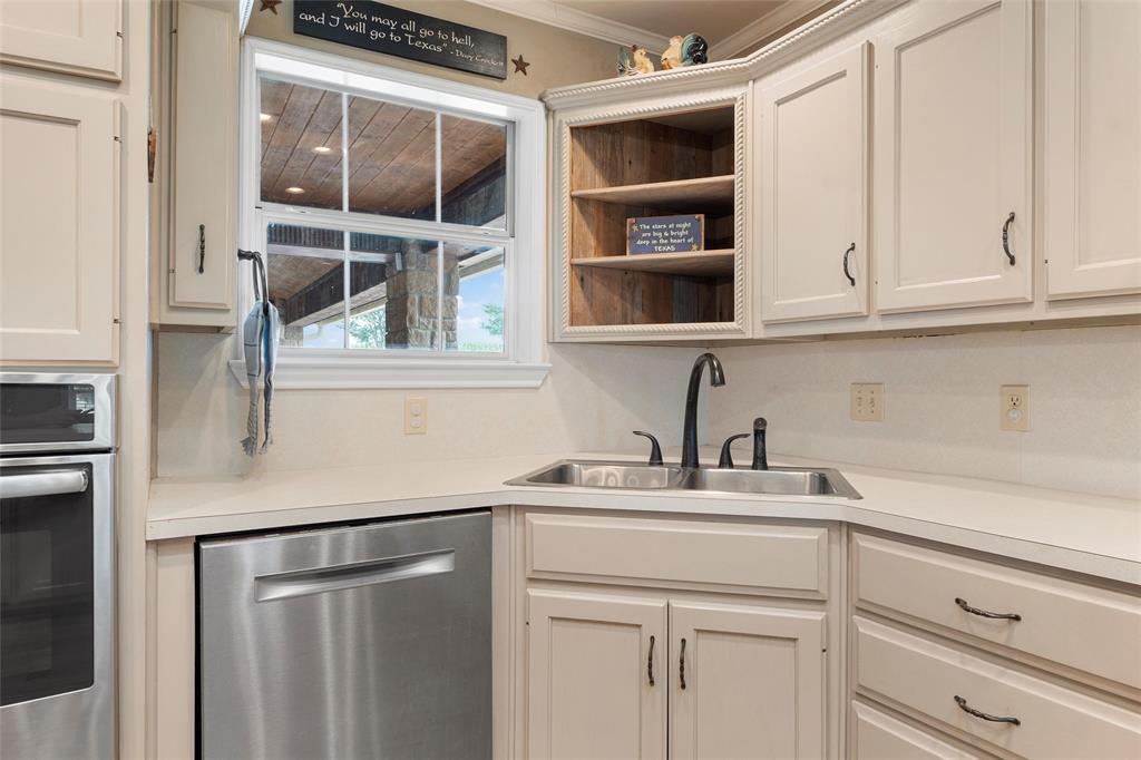 3057 Holy Road Abbott, TX 76621 - Photo 19 of 39 a kitchen with stainless steel appliances cabinets and a window