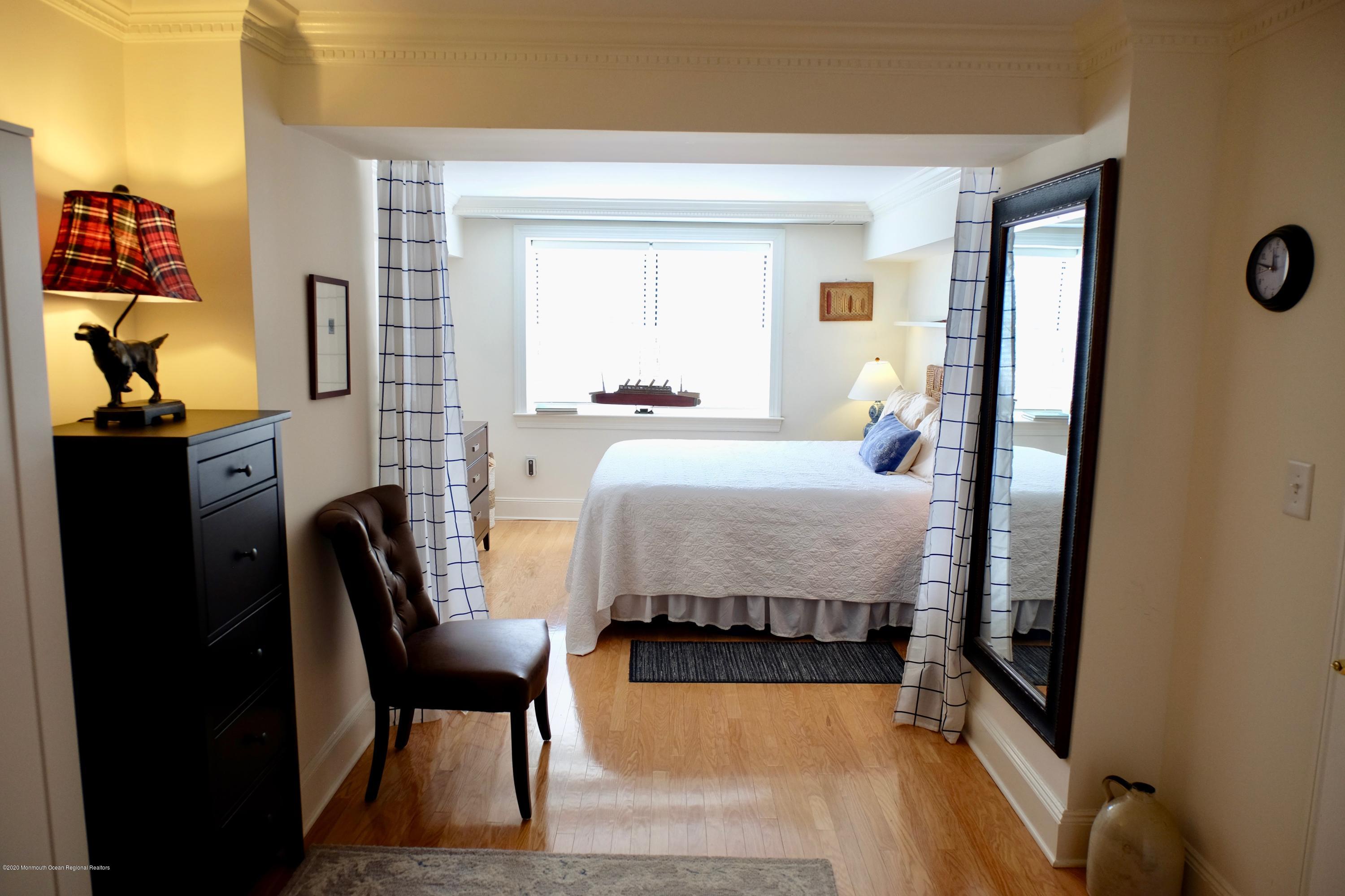 700 Ocean Avenue, Unit G1 Spring Lake, NJ 07762 - Photo 12 of 42 a bedroom with a bed chair and dresser