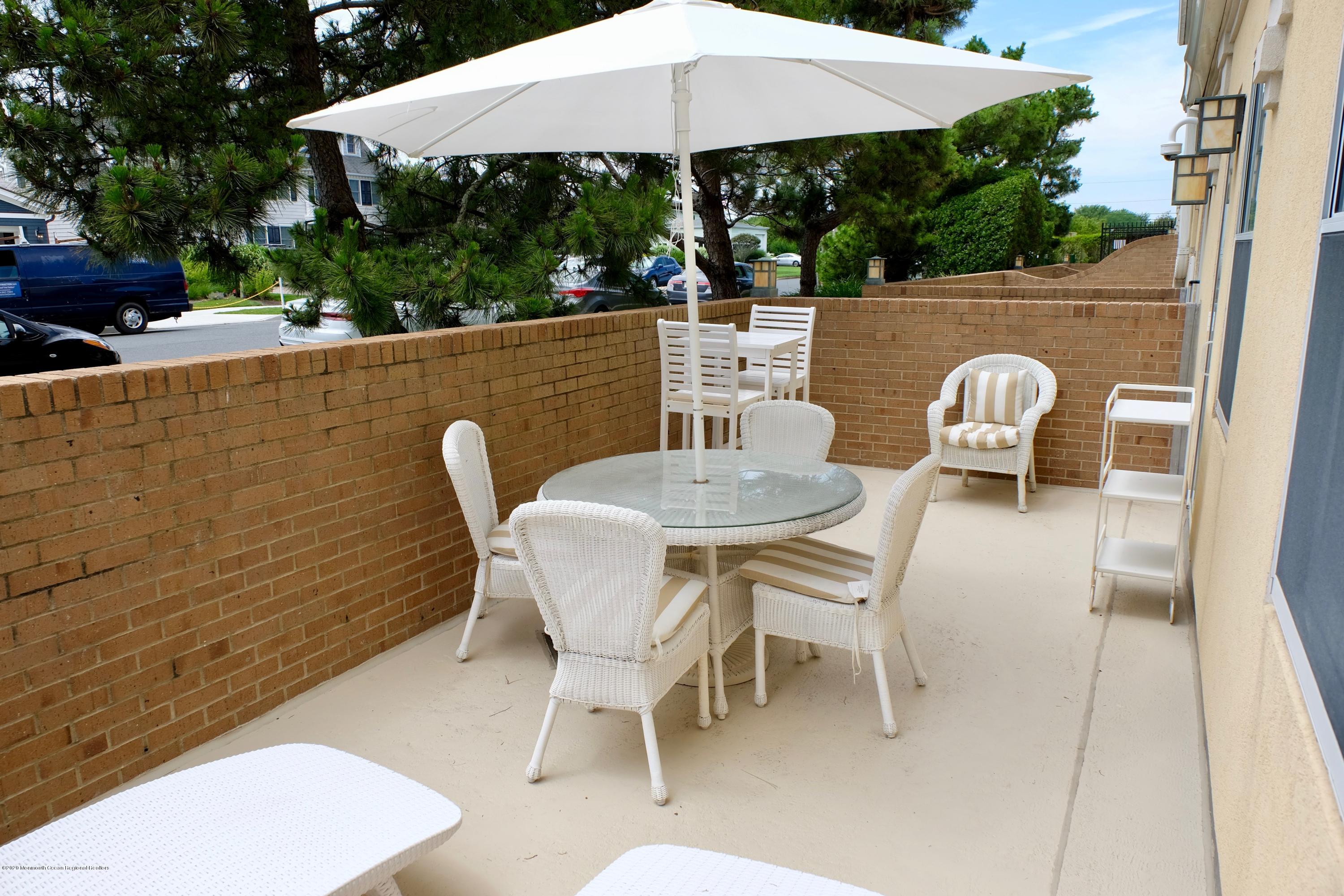700 Ocean Avenue, Unit G1 Spring Lake, NJ 07762 - Photo 18 of 42 a patio with table and chairs