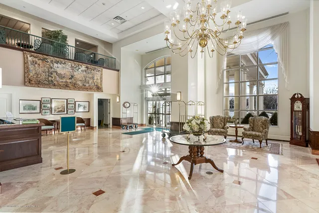 a living room with fireplace furniture and a chandelier