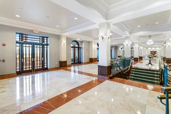 a lobby with furniture and a rug