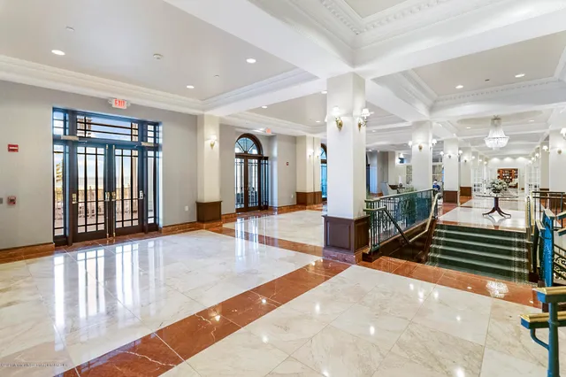 a lobby with furniture and a rug