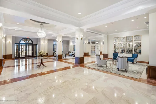 a living room with furniture and a dining table with kitchen view