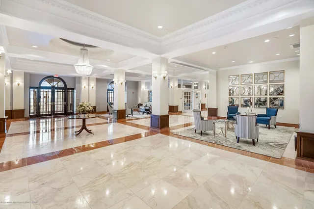 a living room with furniture and a dining table with kitchen view
