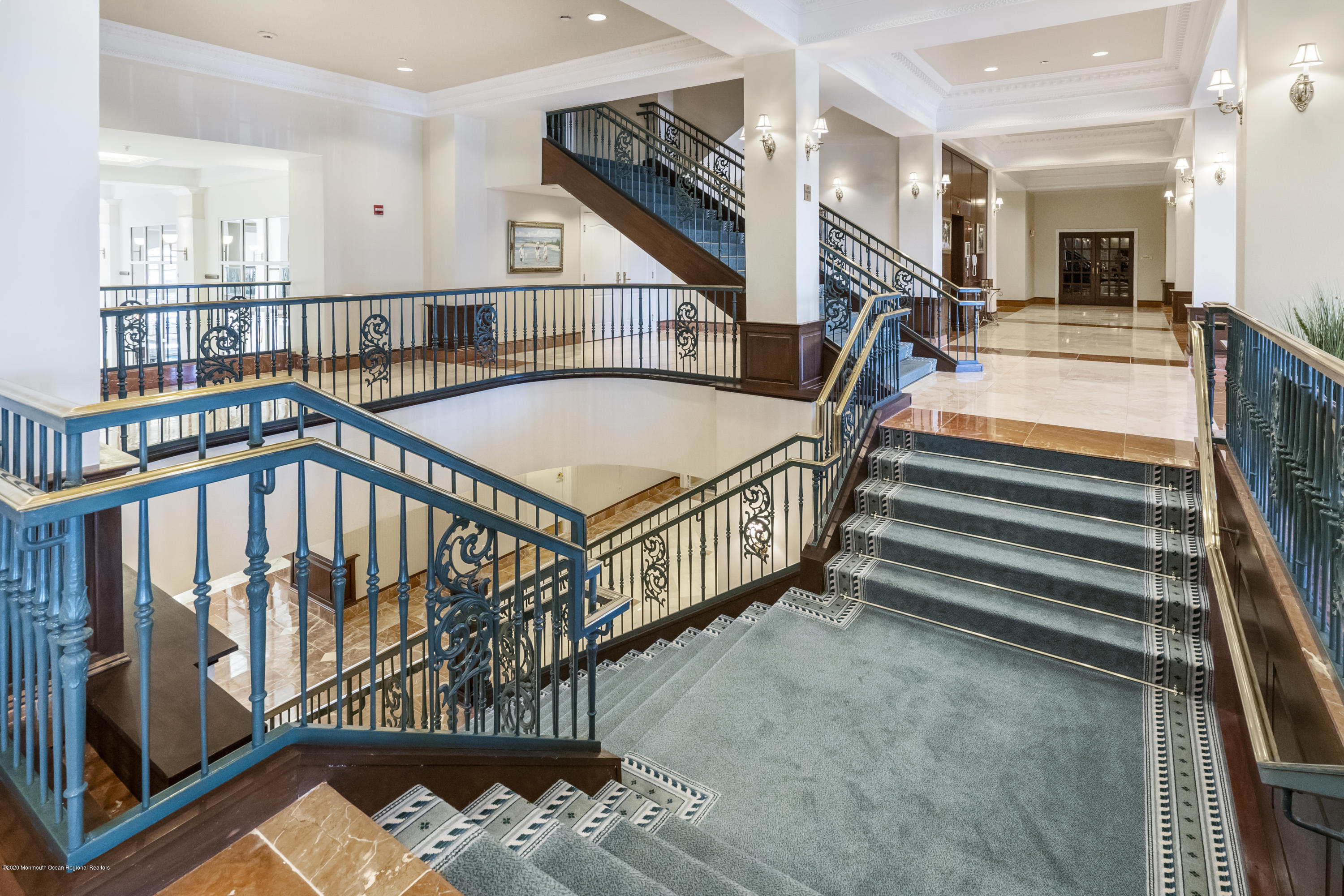 700 Ocean Avenue, Unit G1 Spring Lake, NJ 07762 - Photo 40 of 42 a view of staircase with white walls and a chandelier