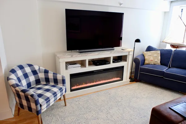 a living room with furniture fireplace and flat screen tv