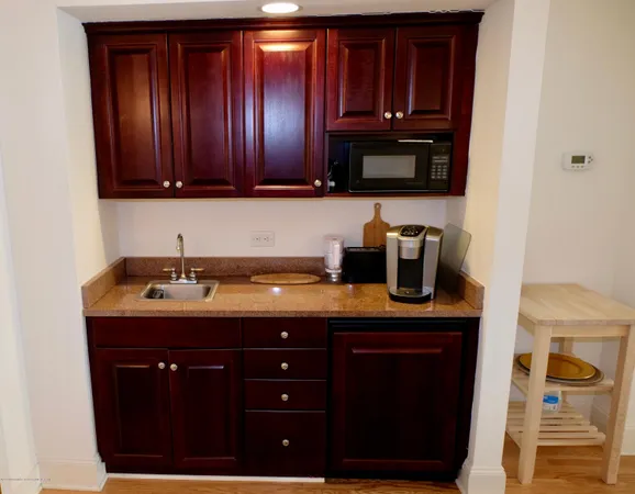 a kitchen with granite countertop wood cabinets and a sink