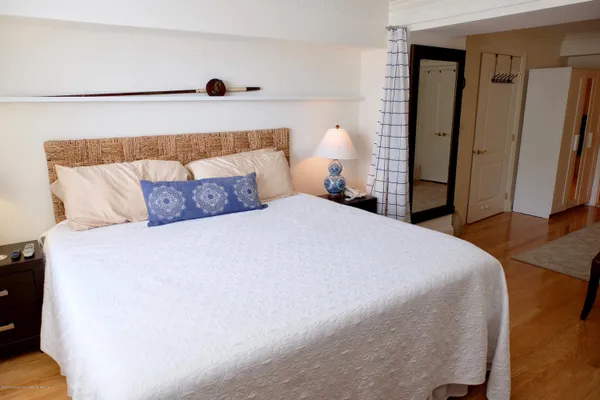 a bedroom with a bed and a night stand