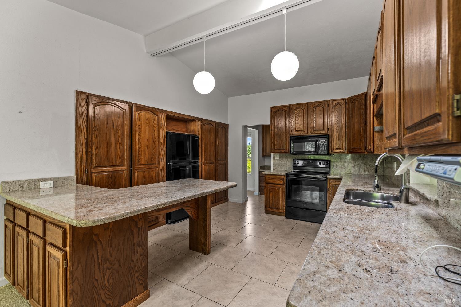 625-629 Hill Road Angwin, CA 94508 - Photo 11 of 64 a kitchen with stainless steel appliances granite countertop a sink refrigerator stove and microwave