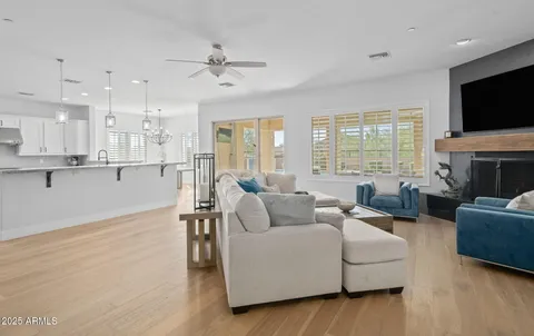 a living room with fireplace furniture and a flat screen tv