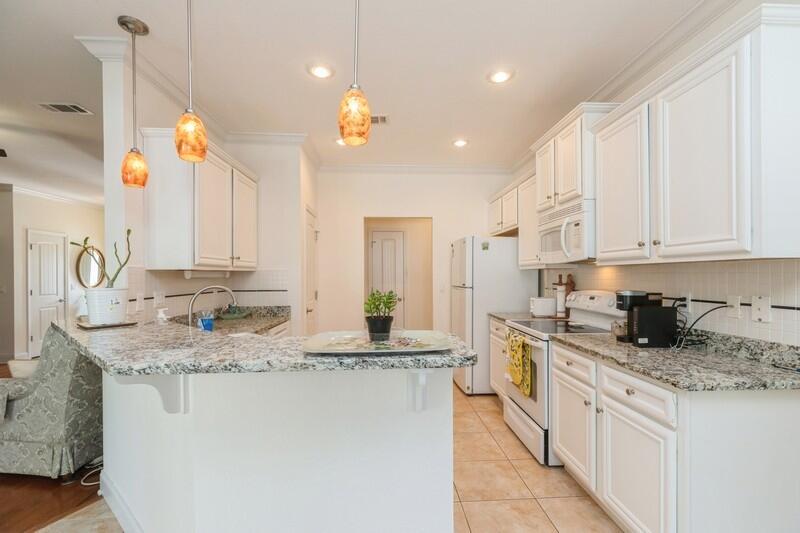 4647 Hermosa Road Crestview, FL 32539 - Photo 13 of 33 a kitchen with stainless steel appliances granite countertop a sink a stove and a granite counter tops