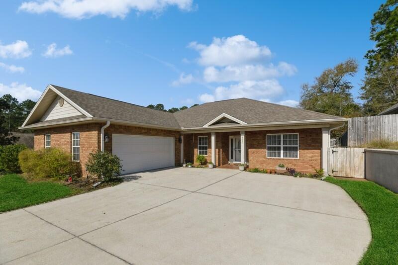 4647 Hermosa Road Crestview, FL 32539 - Photo 2 of 33 a front view of a house with a yard and potted plants