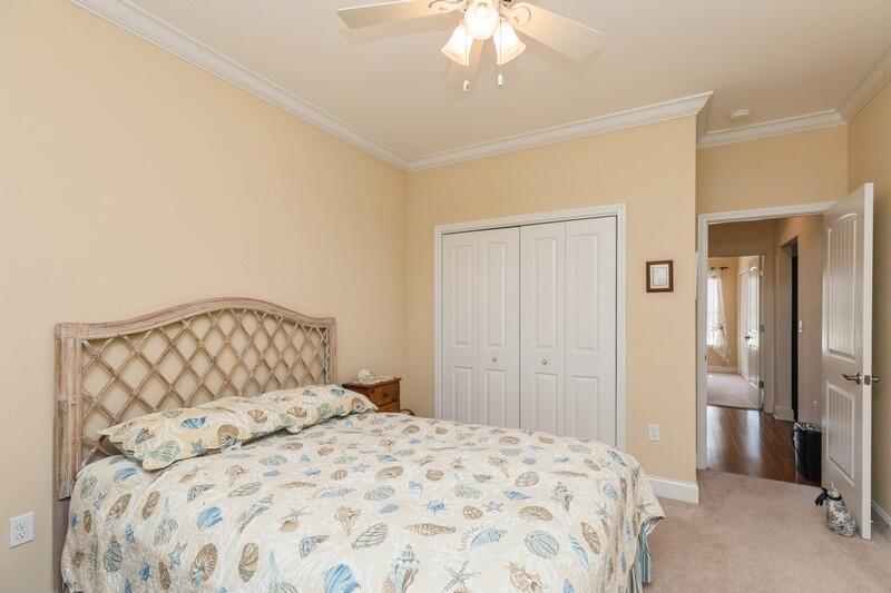 4647 Hermosa Road Crestview, FL 32539 - Photo 22 of 33 a bedroom with a large bed and a chandelier
