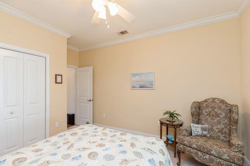 4647 Hermosa Road Crestview, FL 32539 - Photo 23 of 33 a bedroom with a bed and a chandelier