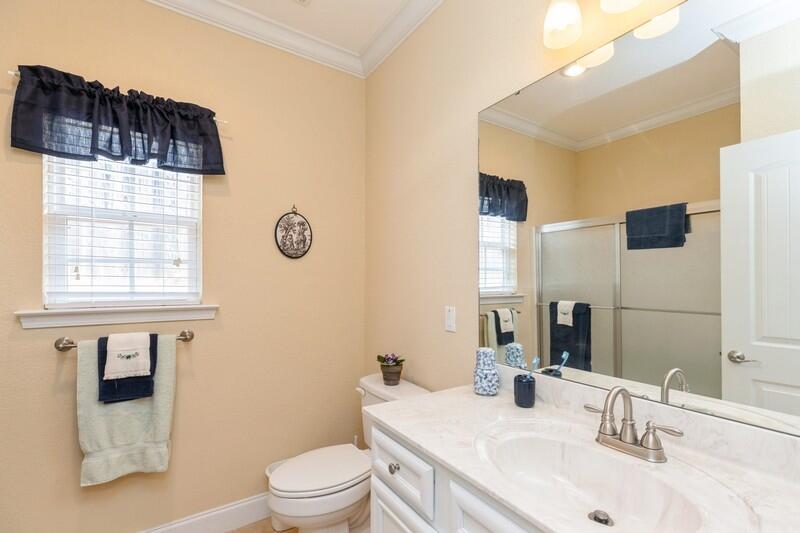 4647 Hermosa Road Crestview, FL 32539 - Photo 24 of 33 a bathroom with a sink a toilet a mirror and shower