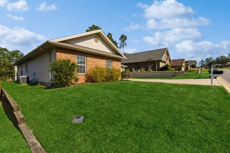 4647 Hermosa Road Crestview, FL 32539 - Photo 3 of 33 a view of a house with a big yard and potted plants