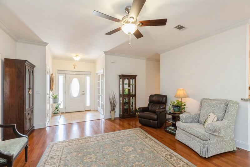 4647 Hermosa Road Crestview, FL 32539 - Photo 9 of 33 a living room with furniture and a flat screen tv