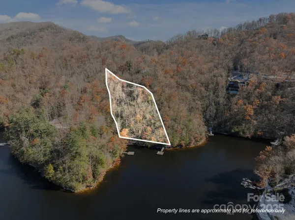 an aerial view of a house with a yard wooden fence and a mountain view